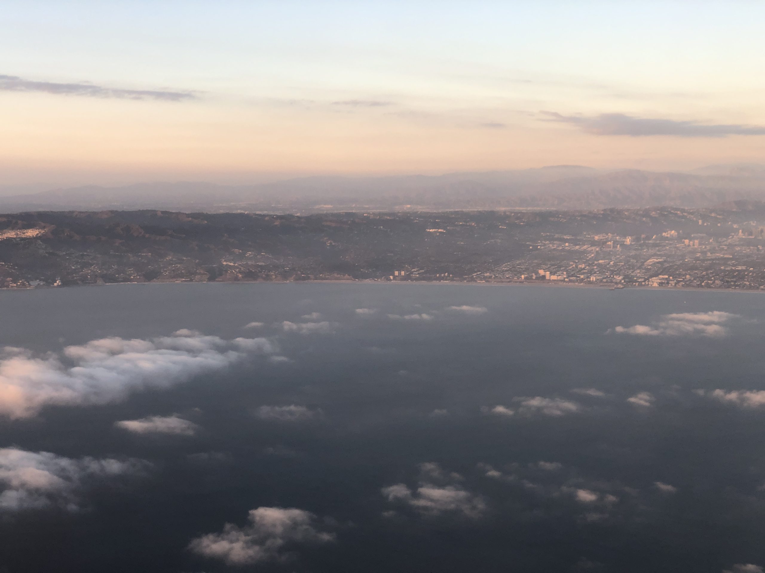Aerial view of Santa Monica Airport runways and surrounding urban area, with the Pacific Ocean in the distance.
