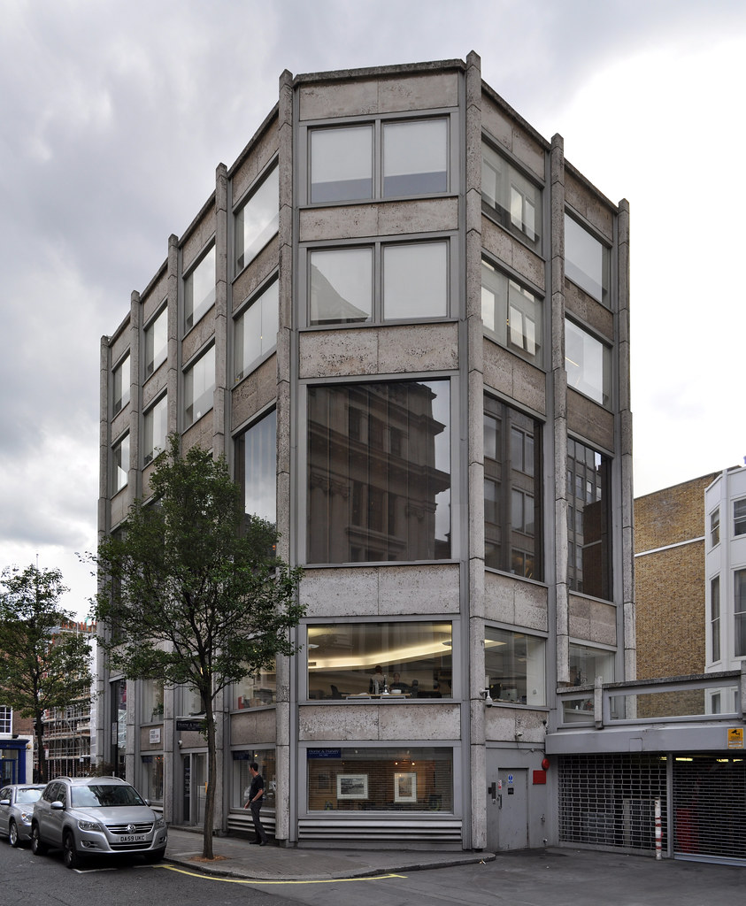 A street scene in London showing a mix of historic and modern architecture with public realm elements.