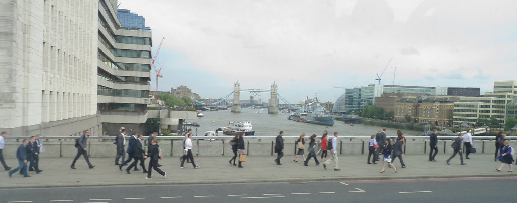 A bustling London Underground station with trains arriving and departing.