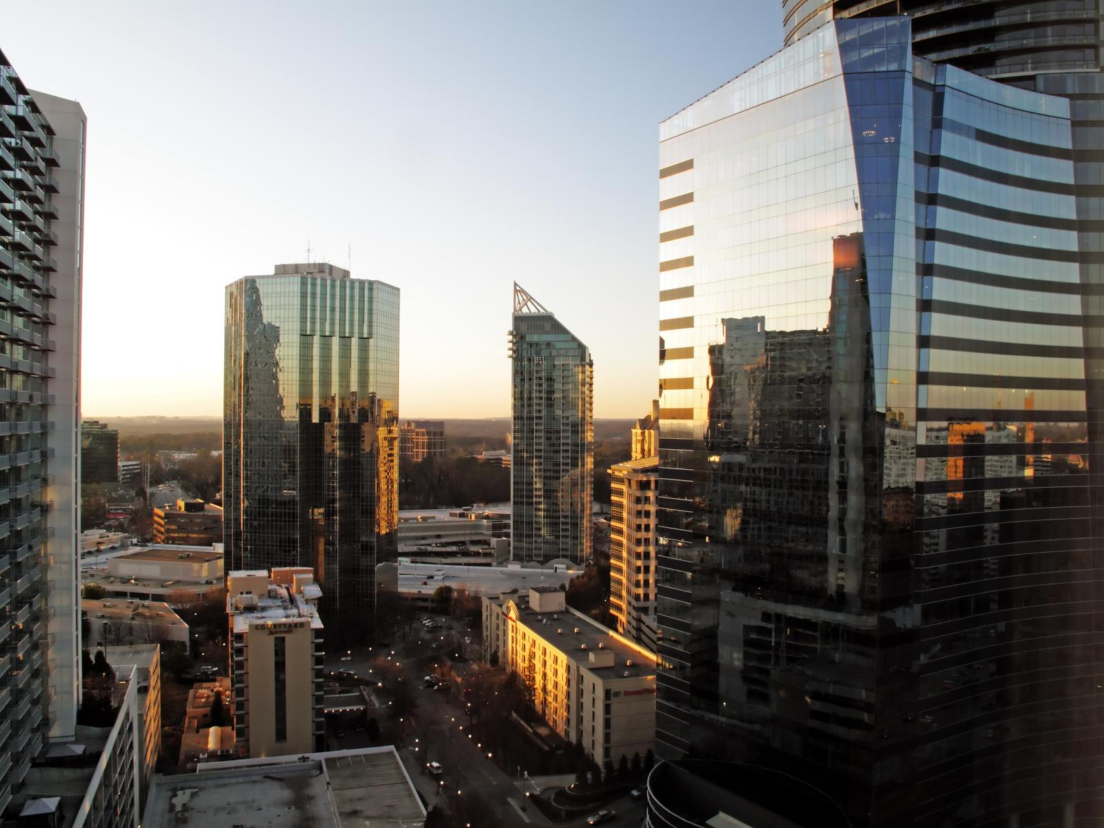 A downtown street with office buildings and minimal foot traffic, illustrating a lack of residential presence.