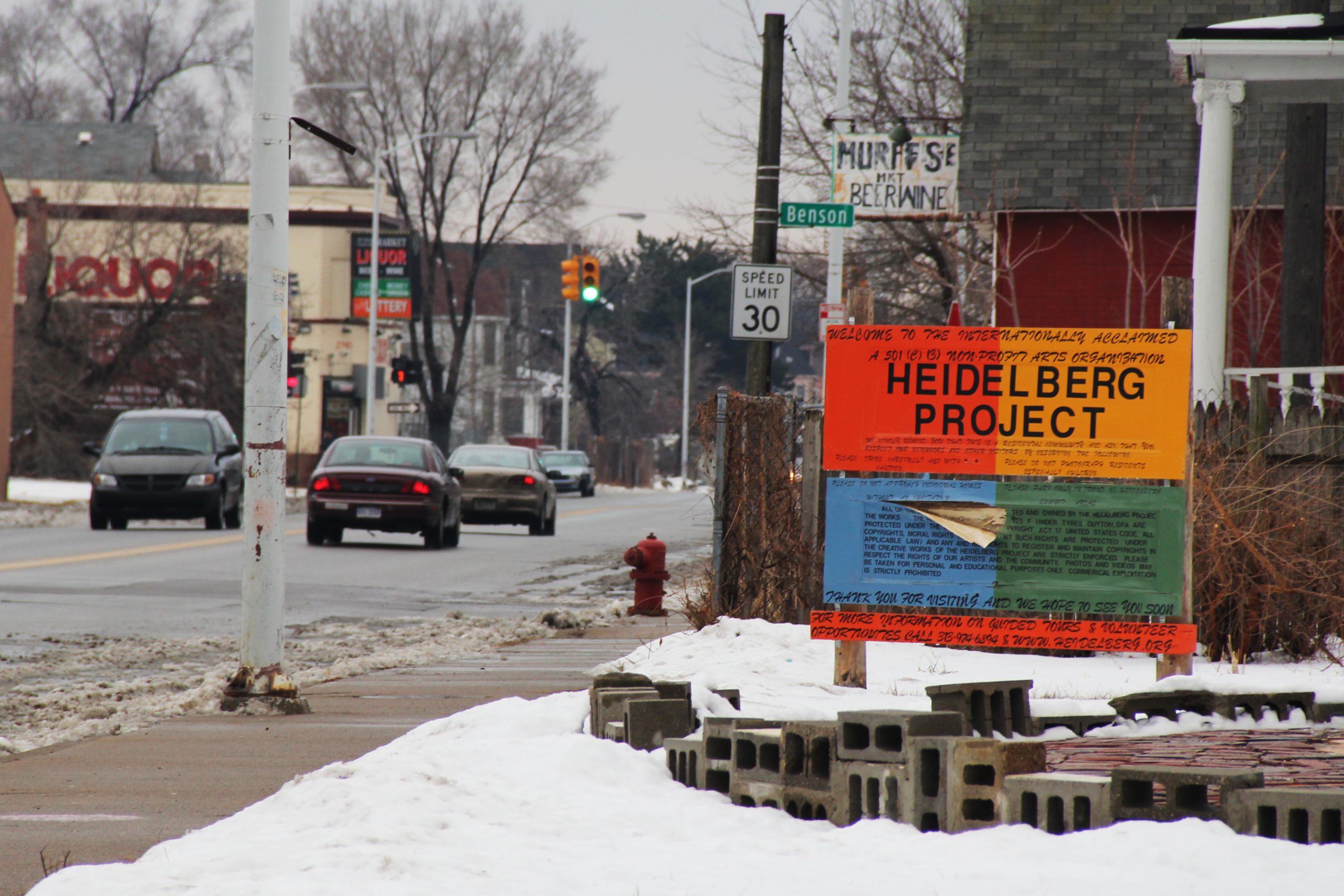 A house adorned with colourful objects and painted patterns, part of the Heidelberg Project in Detroit, illustrating creative building reuse.