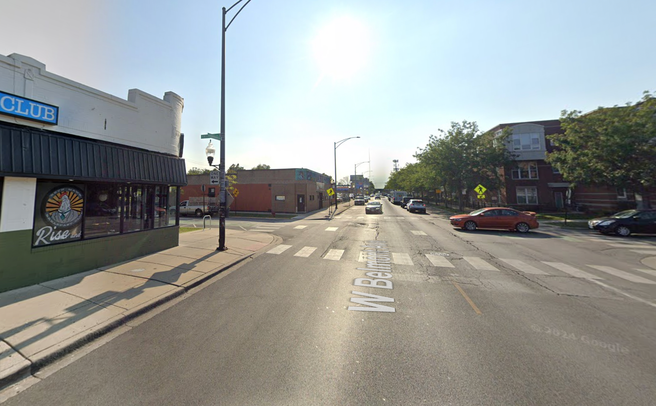 A busy street intersection in Chicago with traffic and pedestrian infrastructure