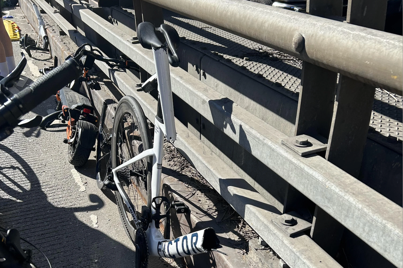 A view of the Queensboro Bridge bike lane with New York City buildings visible.