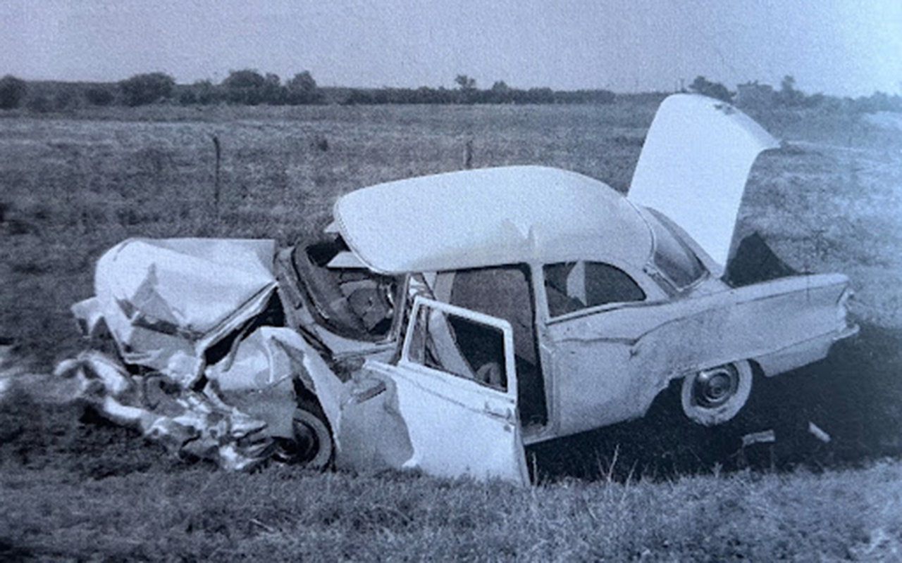 A Route 66 sign with a vintage car in the foreground and a superimposed image of a historical traffic accident in the background.