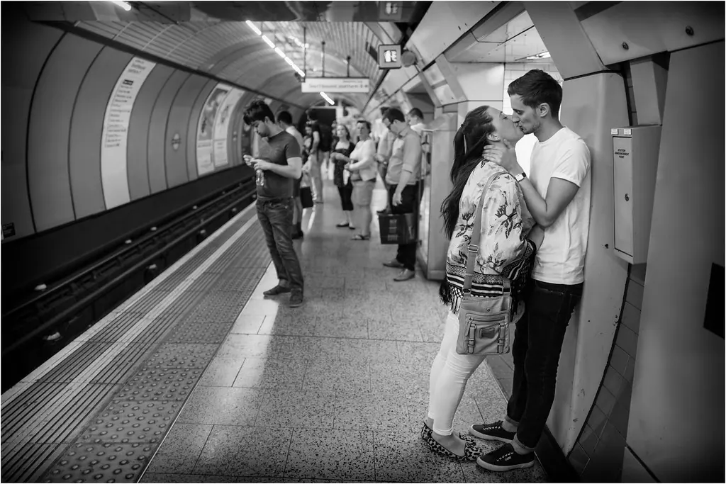 A view of a busy London Underground station with trains arriving and departing.