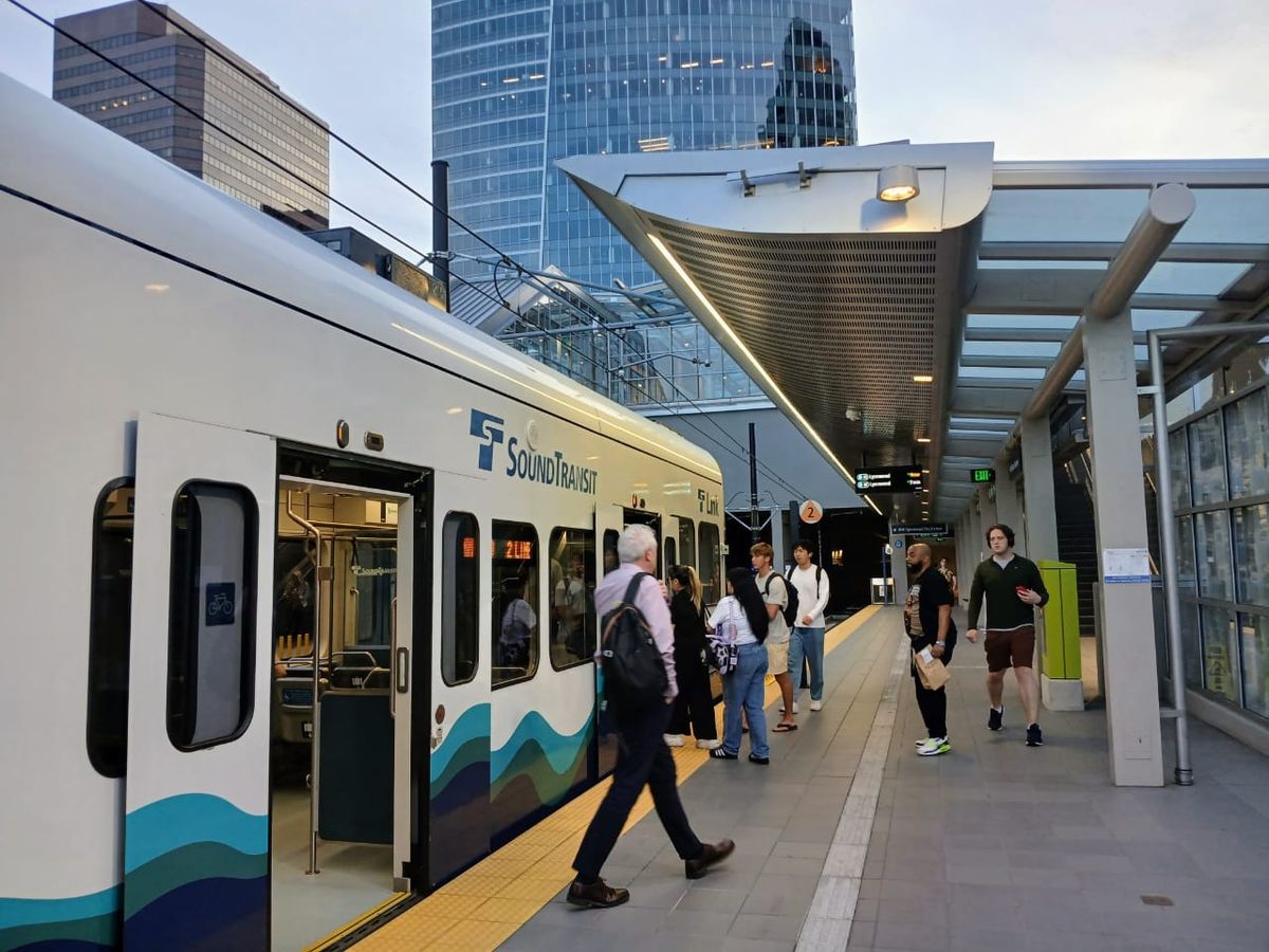 A Sound Transit Link light rail train at an elevated station in Seattle.