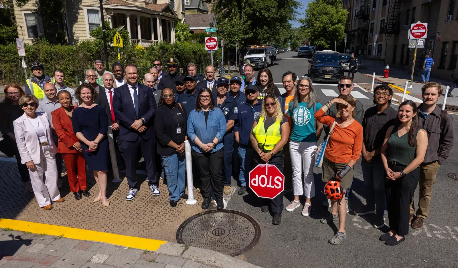 A street in Jersey City, New Jersey, featuring new traffic calming infrastructure like curb extensions and pedestrian crossing enhancements.