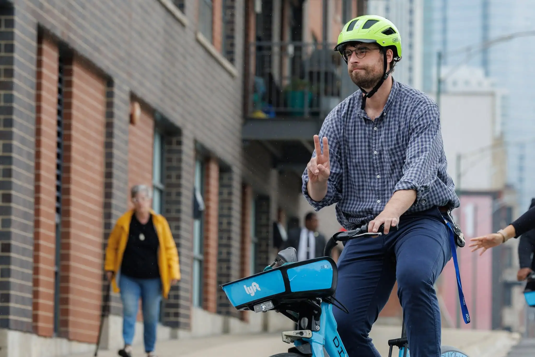 A street scene in Chicago showing a mix of vehicle and bicycle traffic on Halsted Street.