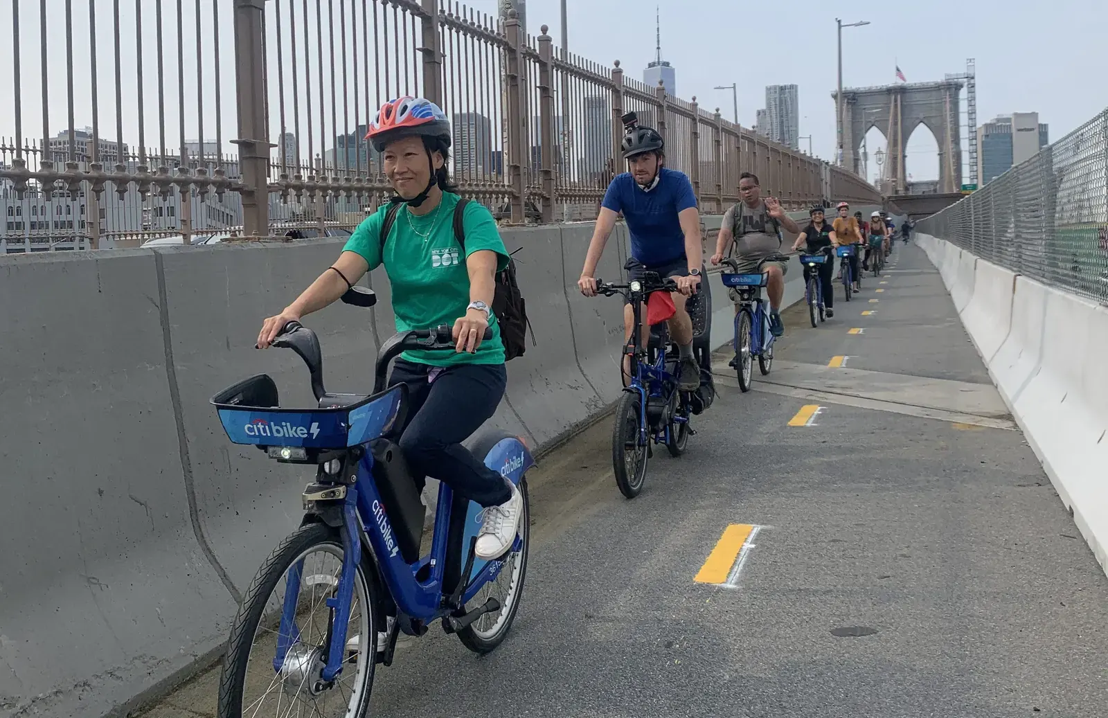 A dedicated bike lane with cyclists riding through a city street.