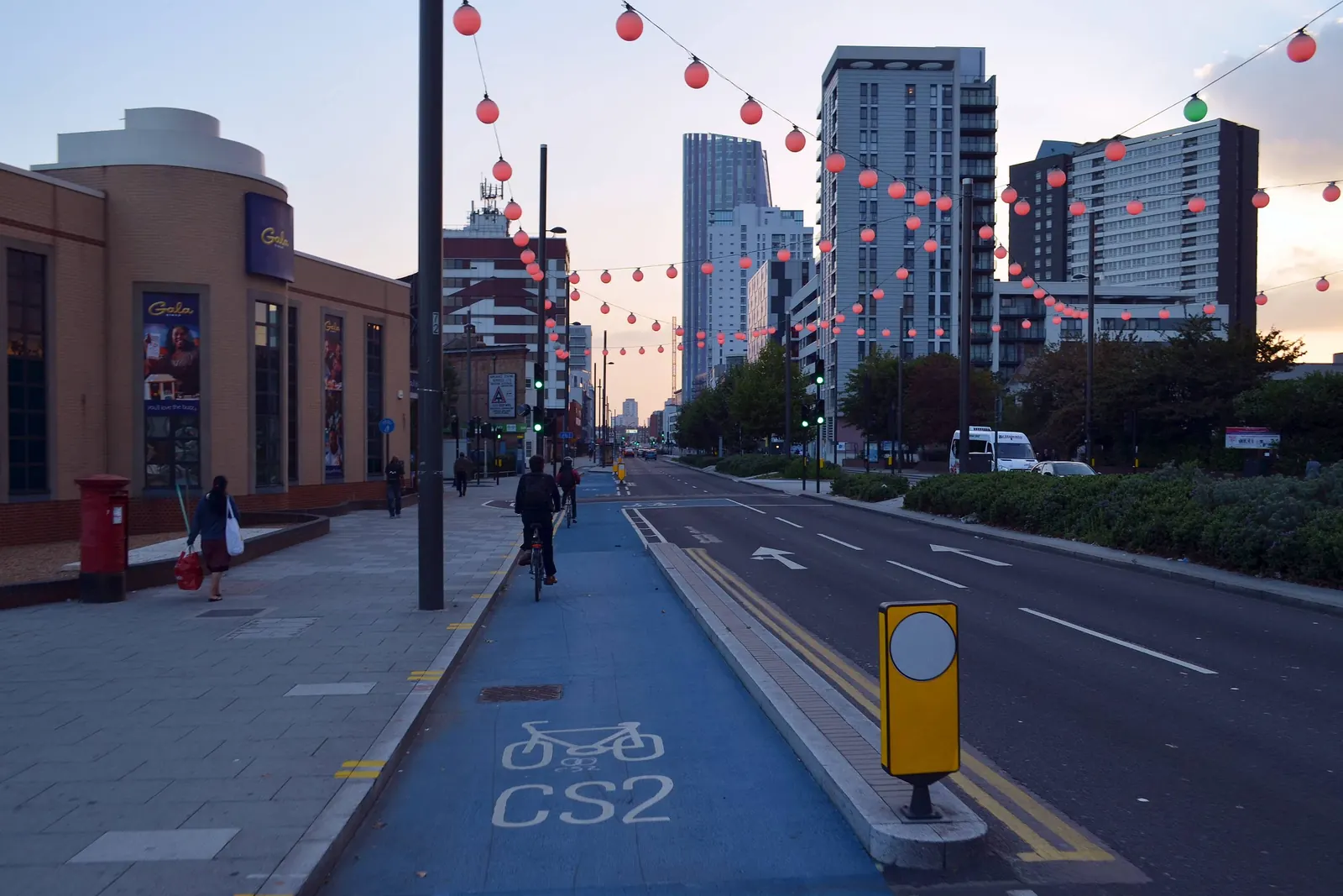 A vibrant London high street with a mix of shops, cafes, and pedestrians.