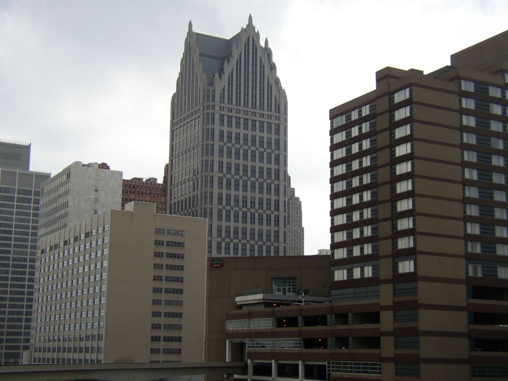 A street scene in downtown Detroit, Michigan, featuring buildings and pedestrian activity.