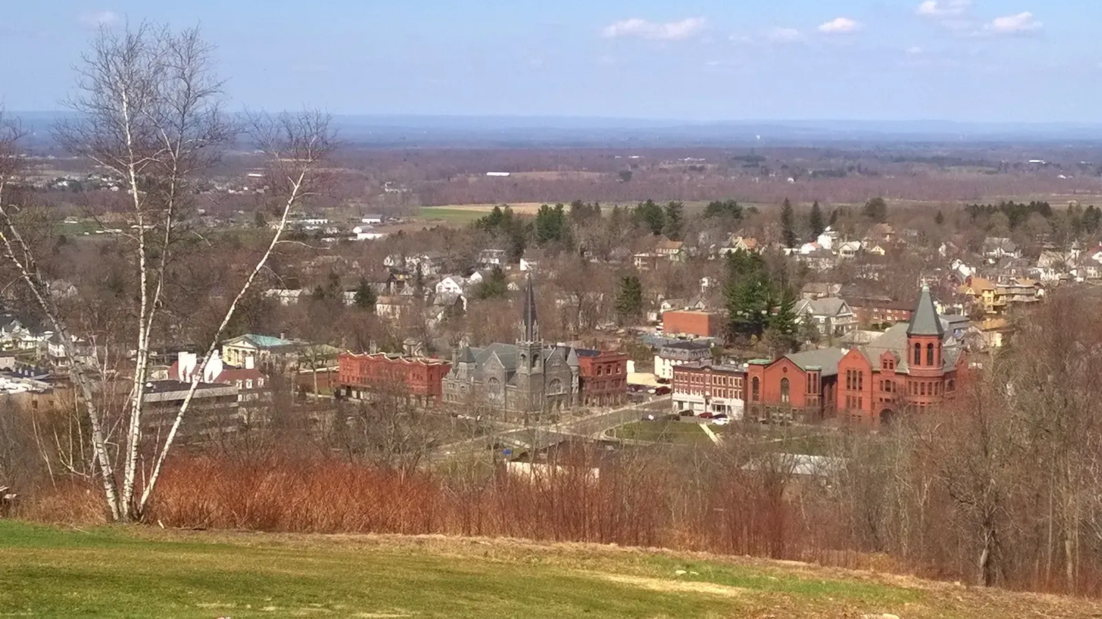 Street view of a residential neighborhood in Rockville, Maryland, with a mix of housing types.