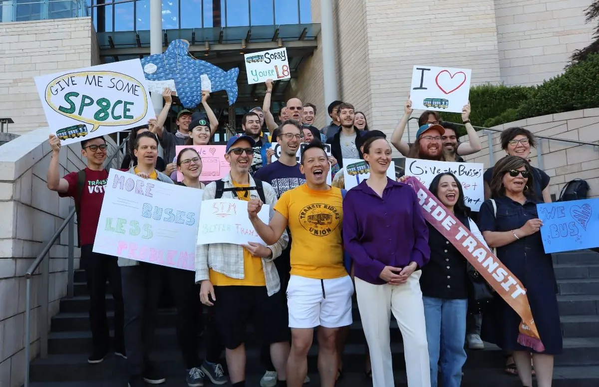 Seattle City Hall with a crowd gathered for a rally supporting public transit.