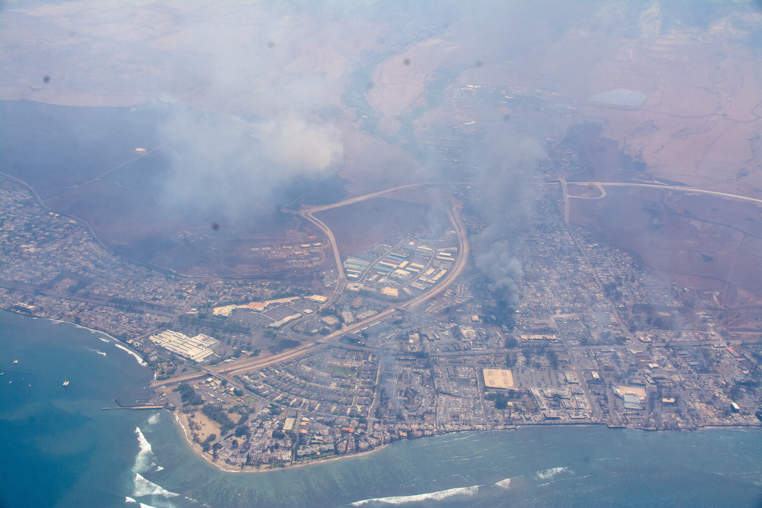 Aerial view of a large wildfire burning through a forested area in the United States.
