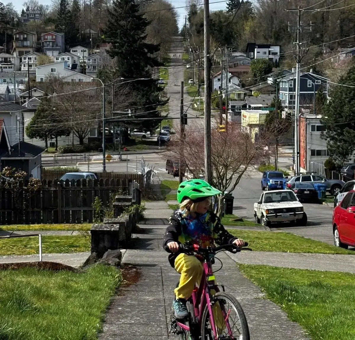 A street in Seattle's Rainier Valley, showing a mix of vehicles, pedestrians, and potential bike lanes.