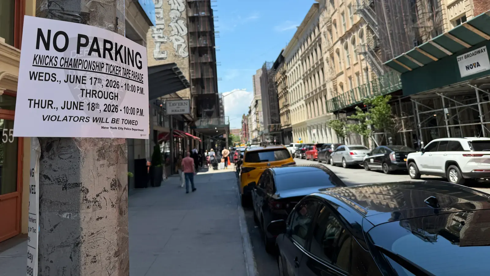 A street in Lower Manhattan, south of Canal Street, with temporary police barriers in place.