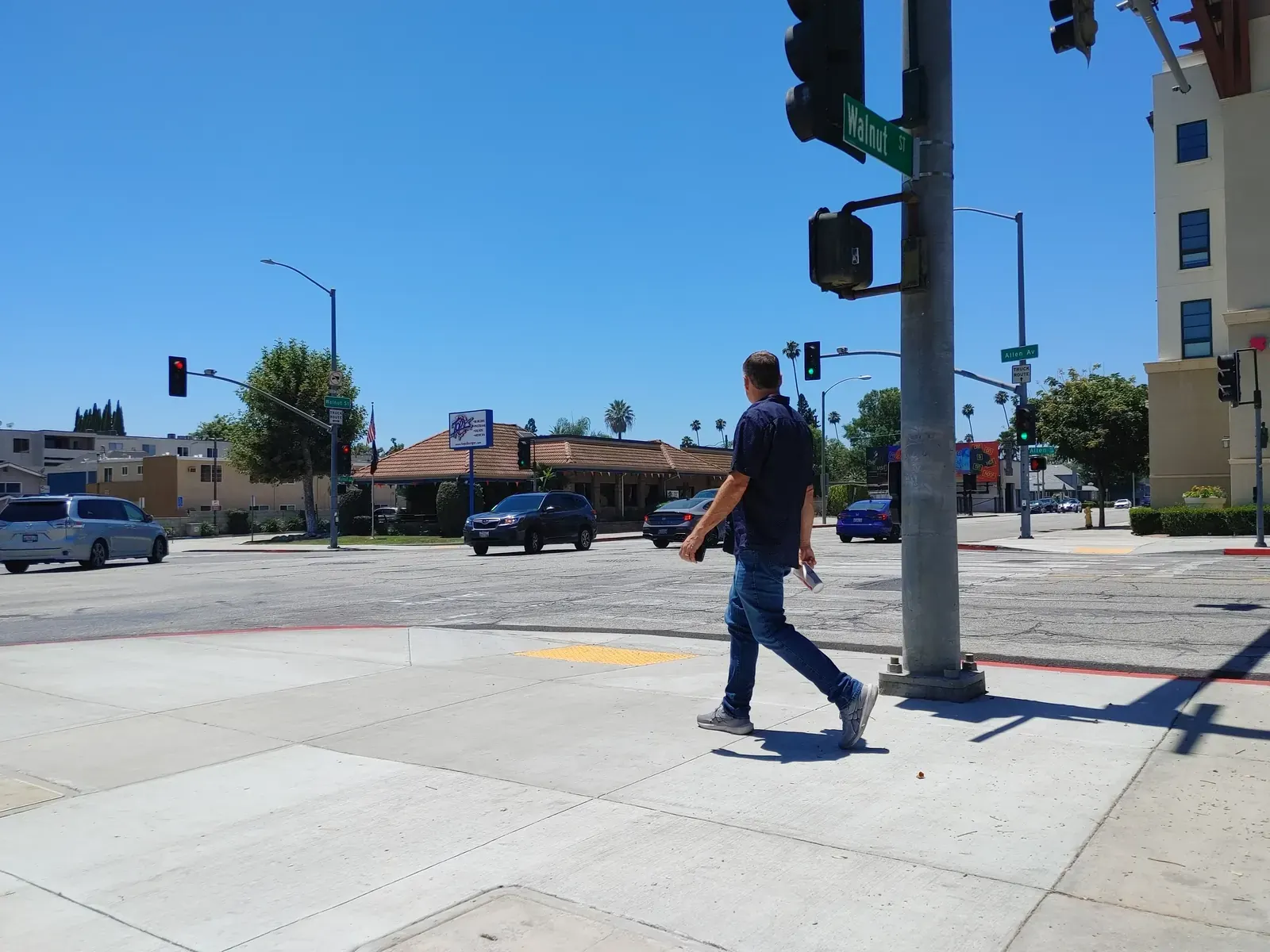 Pedestrian bulb-outs and a new crosswalk on Allen Avenue in Pasadena, California, with a Metro A Line station in the background.