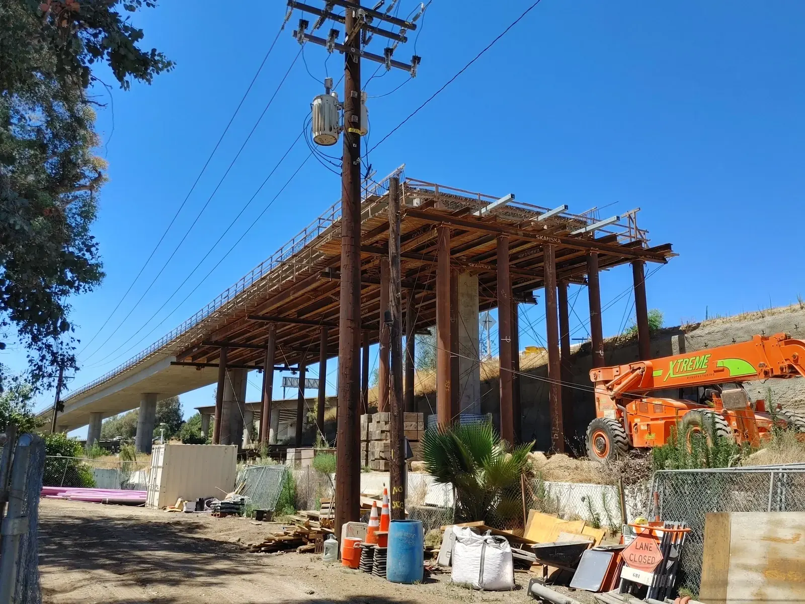 Aerial view of the SR 57/60 interchange construction in Diamond Bar, California, showing the new bypass viaduct and Grand Avenue bridge work, July 2026.