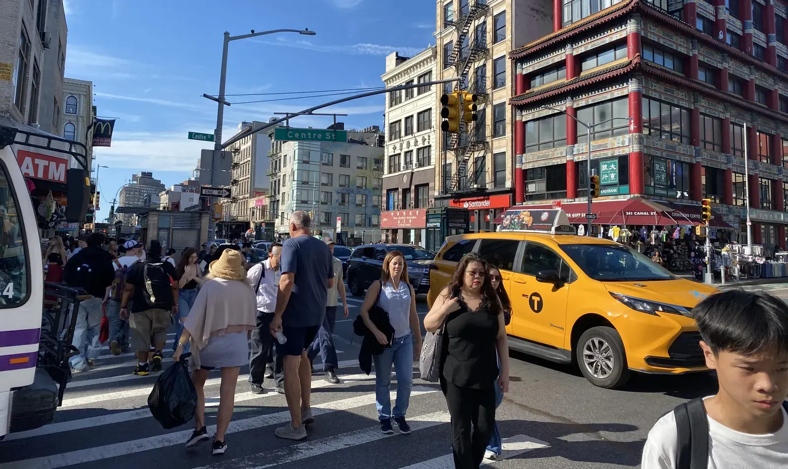 A view of Canal Street in New York City, showing traffic and pedestrian activity.