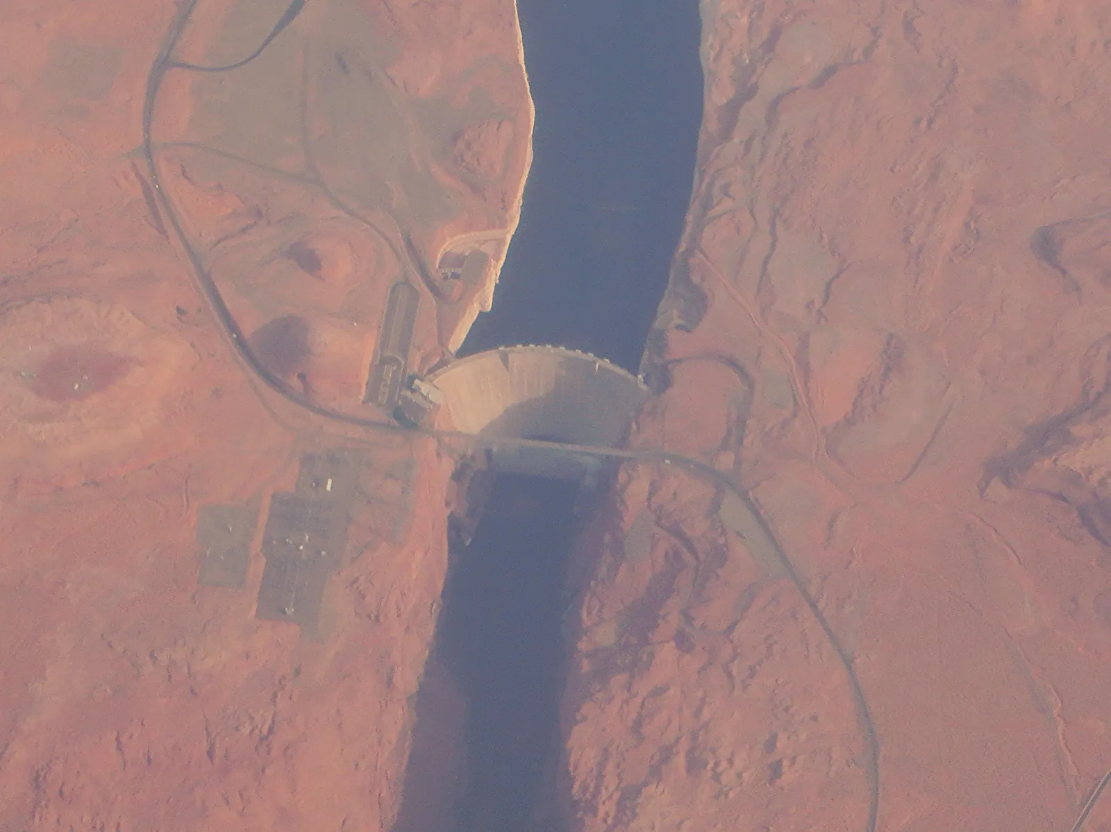 Lake Powell reservoir during a drought, with significantly lowered water levels and exposed shorelines.