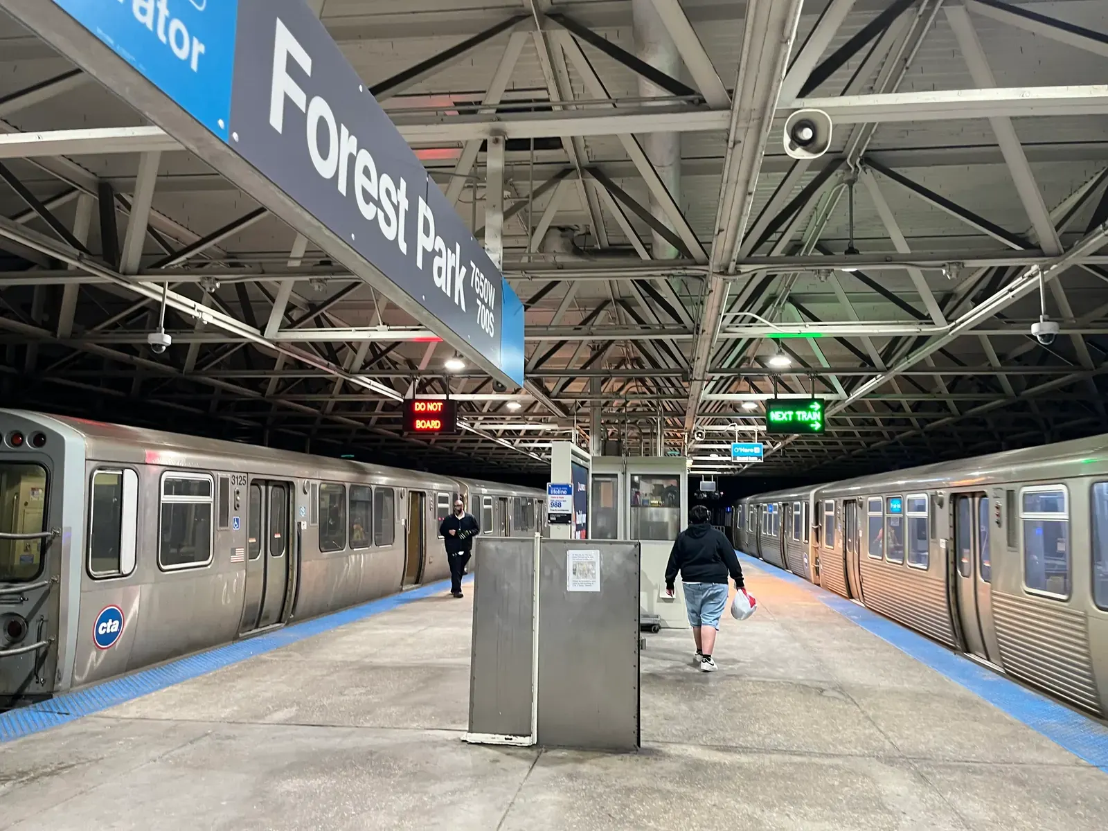 A Chicago Transit Authority Blue Line train at a station platform on the Forest Park Branch.