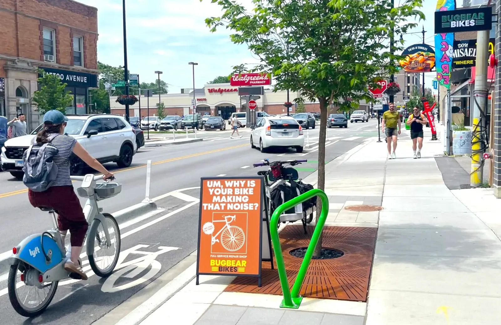 Cyclists and pedestrians using the new protected bike lanes and public plaza on Lincoln Avenue in Chicago.