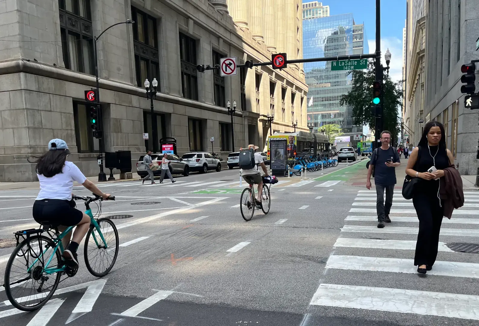 A street in Chicago with a painted bicycle lane alongside vehicular traffic.