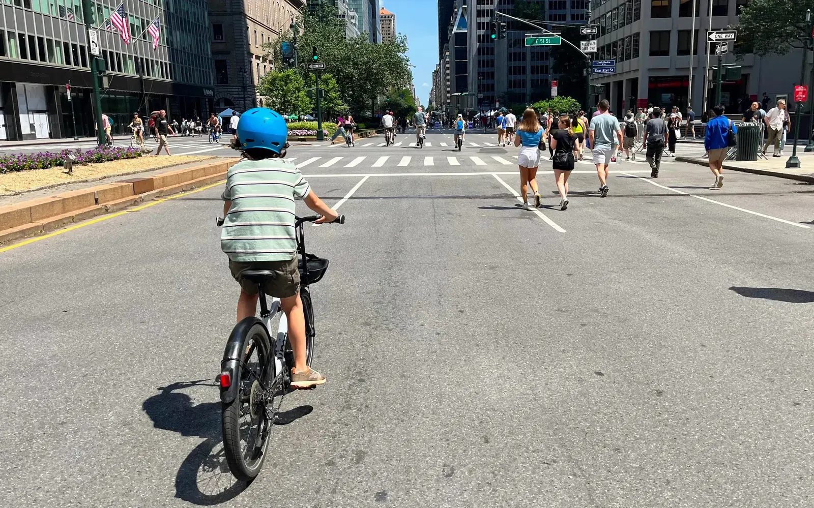 A street in New York City with barriers and signage indicating it is closed to vehicle traffic for the Summer Streets program.