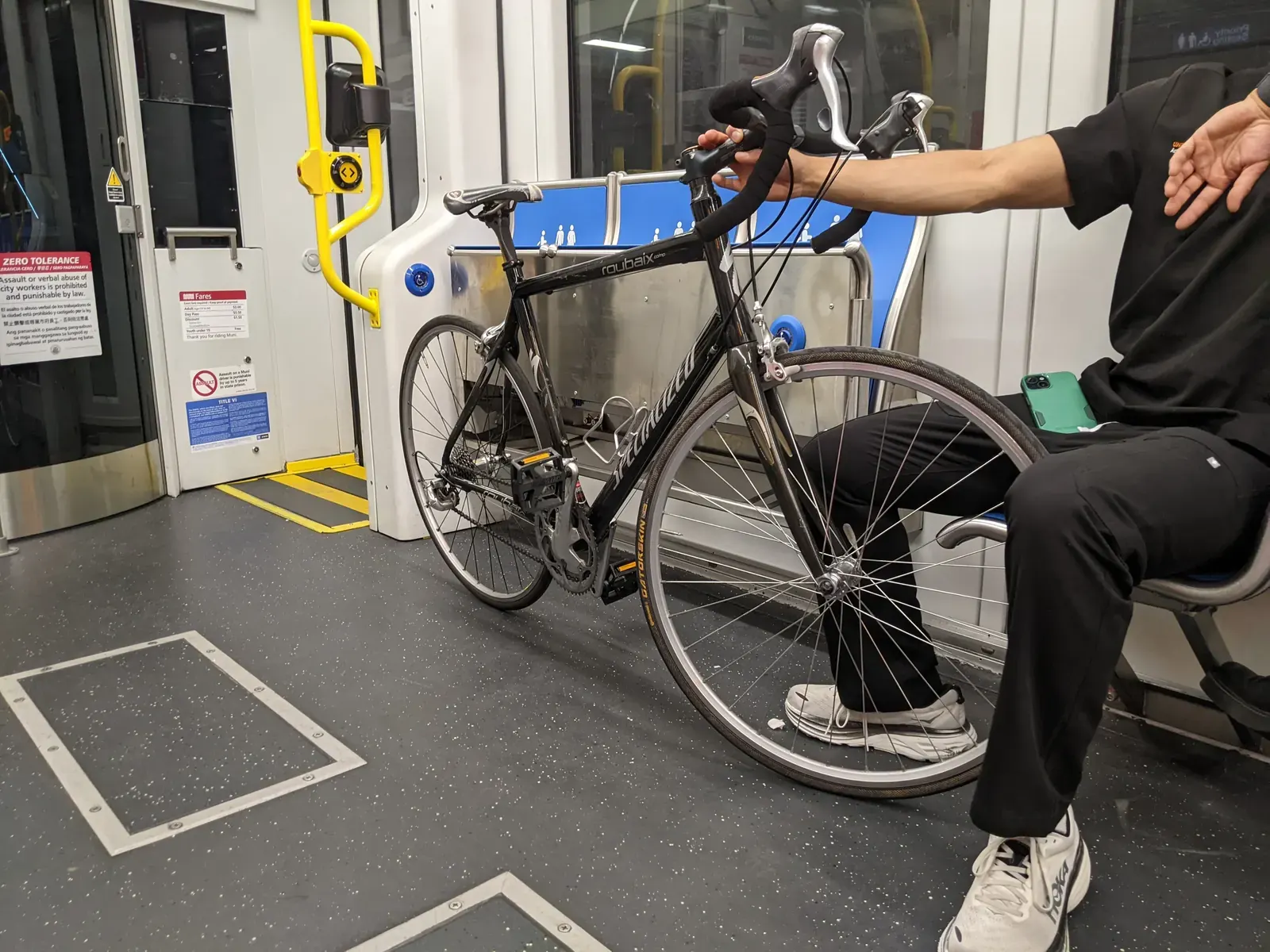 A San Francisco Muni train with bicycles being transported on an exterior rack.