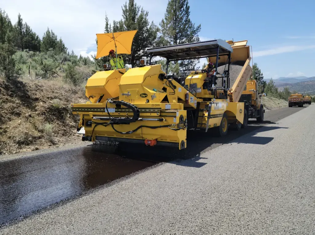 Road maintenance works on a London street with cones, barriers and resurfacing equipment