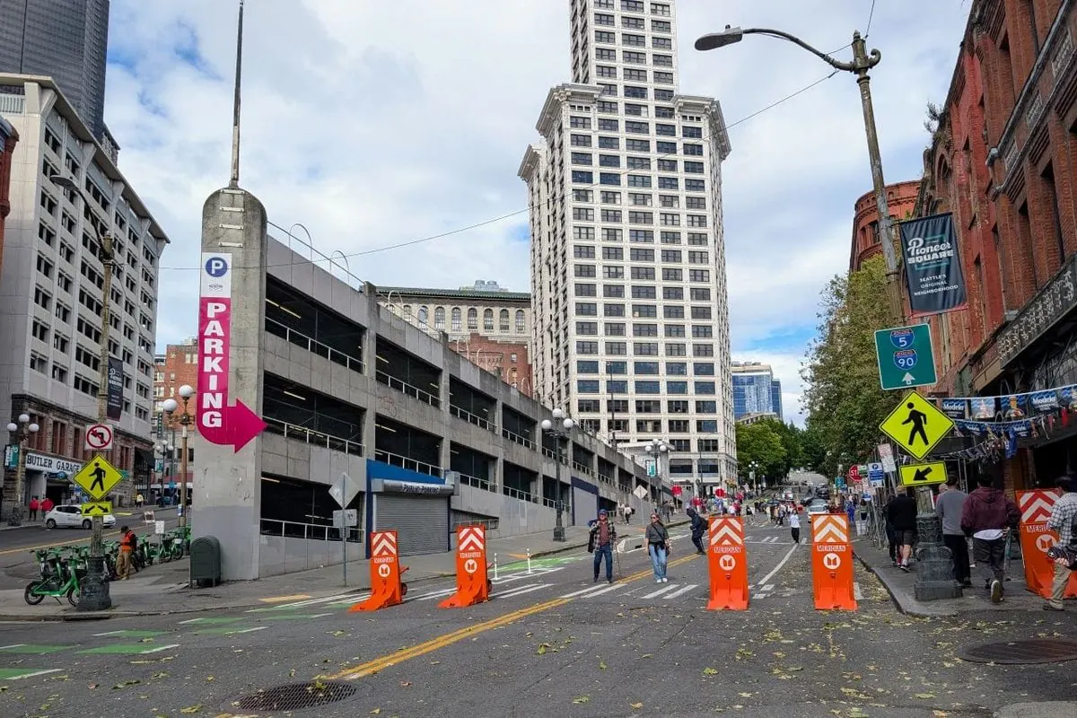 Crowds moving through a city-centre street with public transport access during a major event