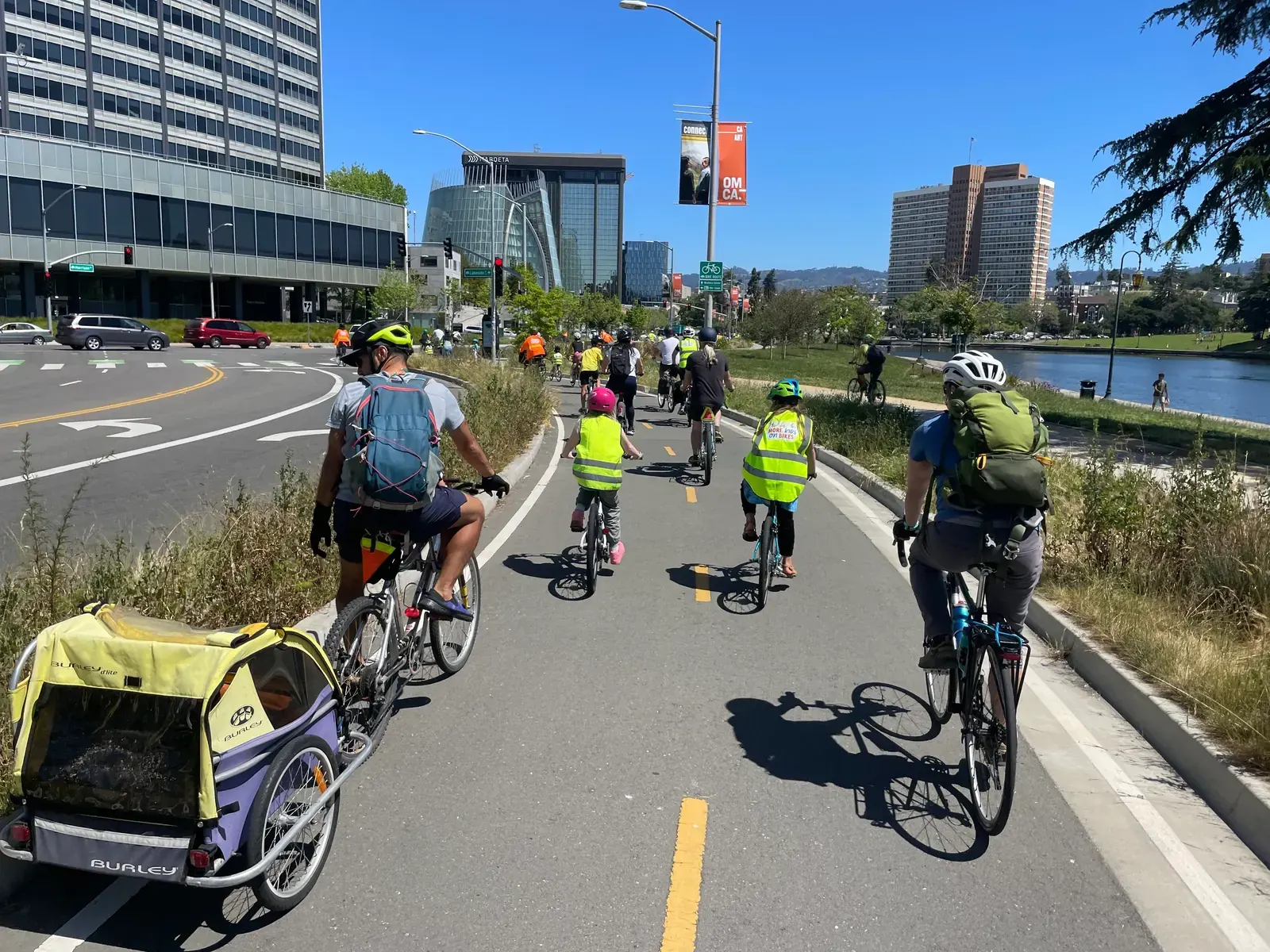 A cyclist rides in a physically separated bike lane on a city street.