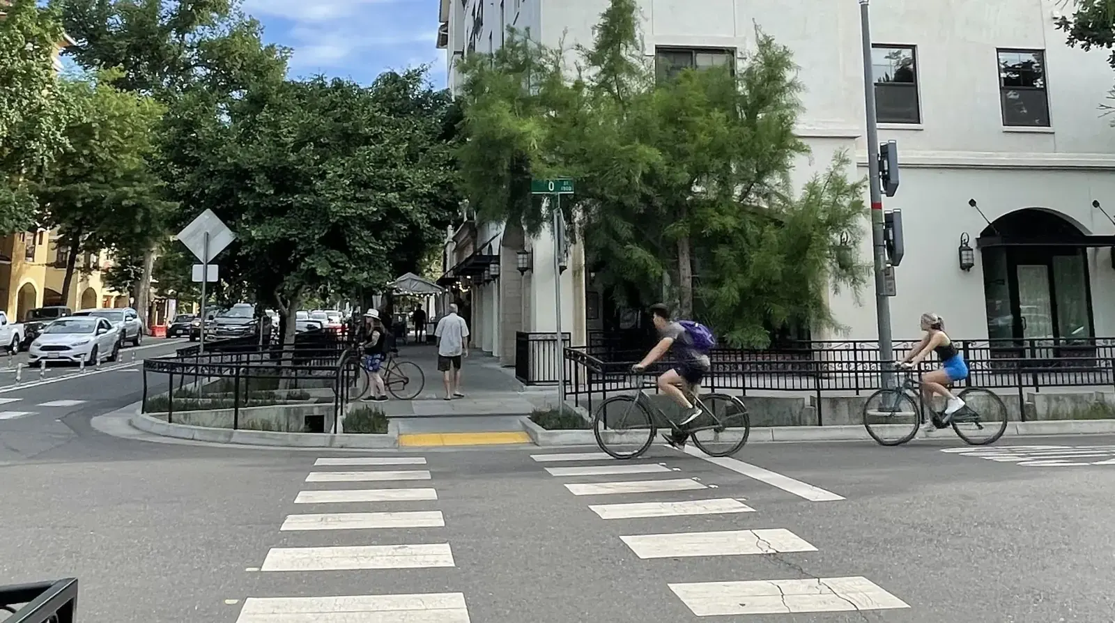 A cyclist riding in a dedicated bike lane on a city street in California.