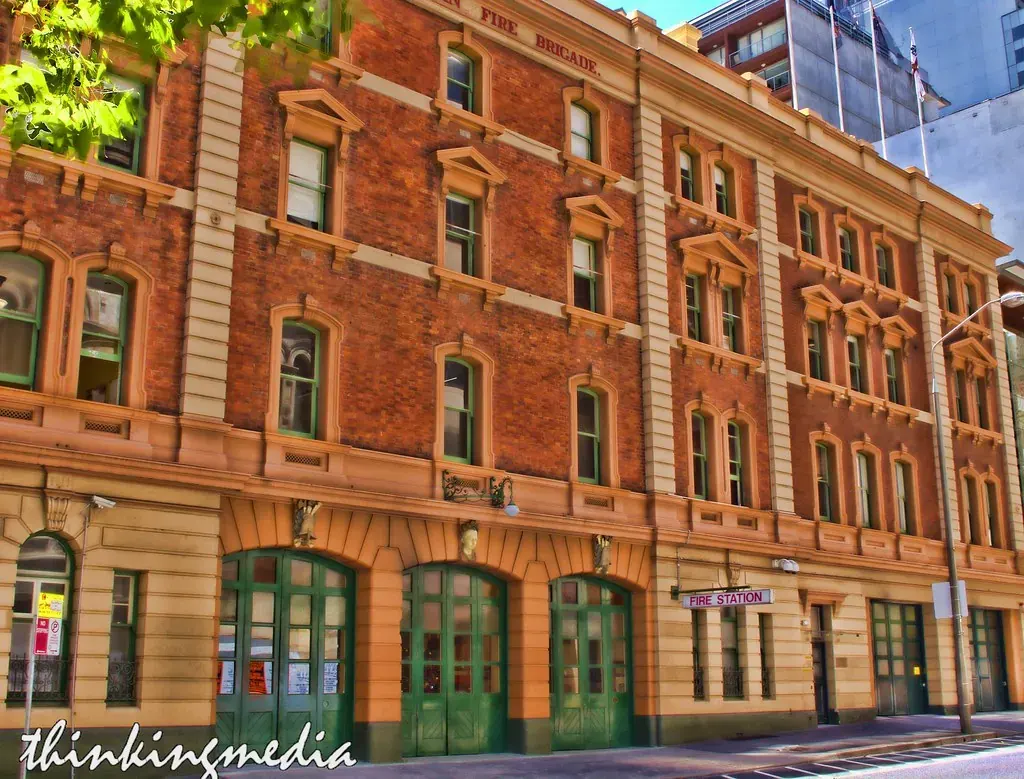 London fire station building situated on an urban street corner with contemporary public realm design.