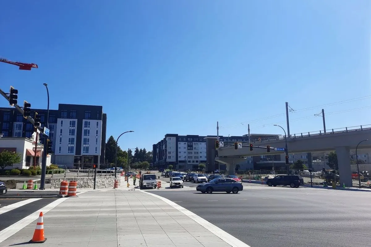 Urban street intersection with pedestrian safety infrastructure and traffic calming measures.