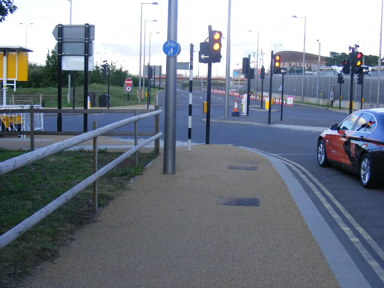 A busy London street with traffic, a red double-decker bus, cycle lane markings, and pedestrian crossing, illustrating road safety challenges in the capital
